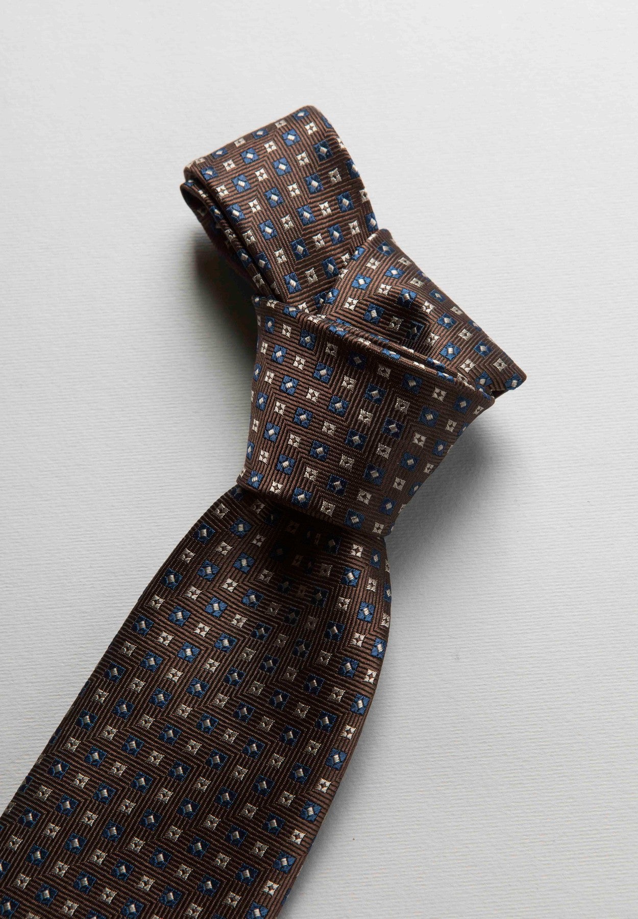 Brown tie with blue-beige check pattern