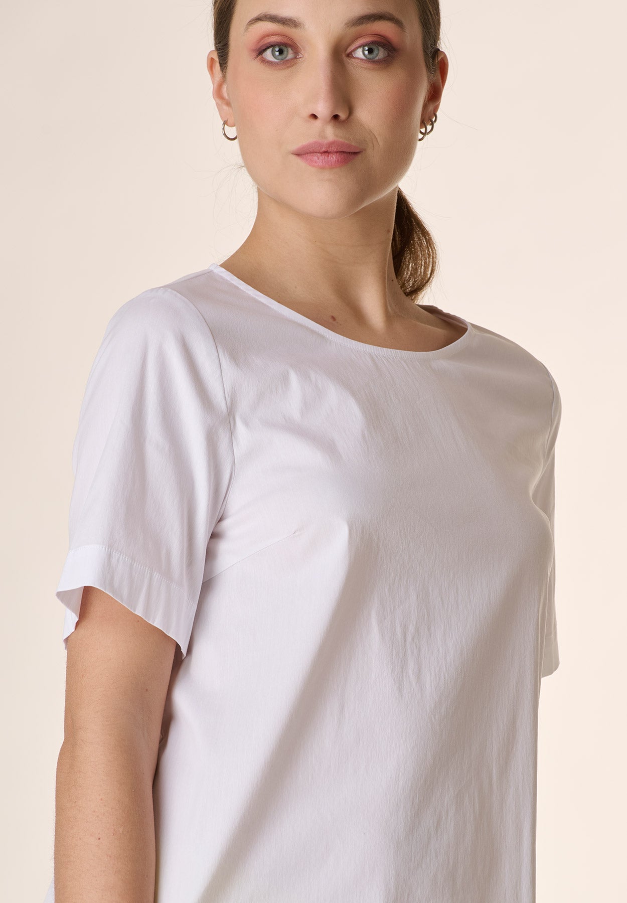 White crew-neck blouse with rounded back