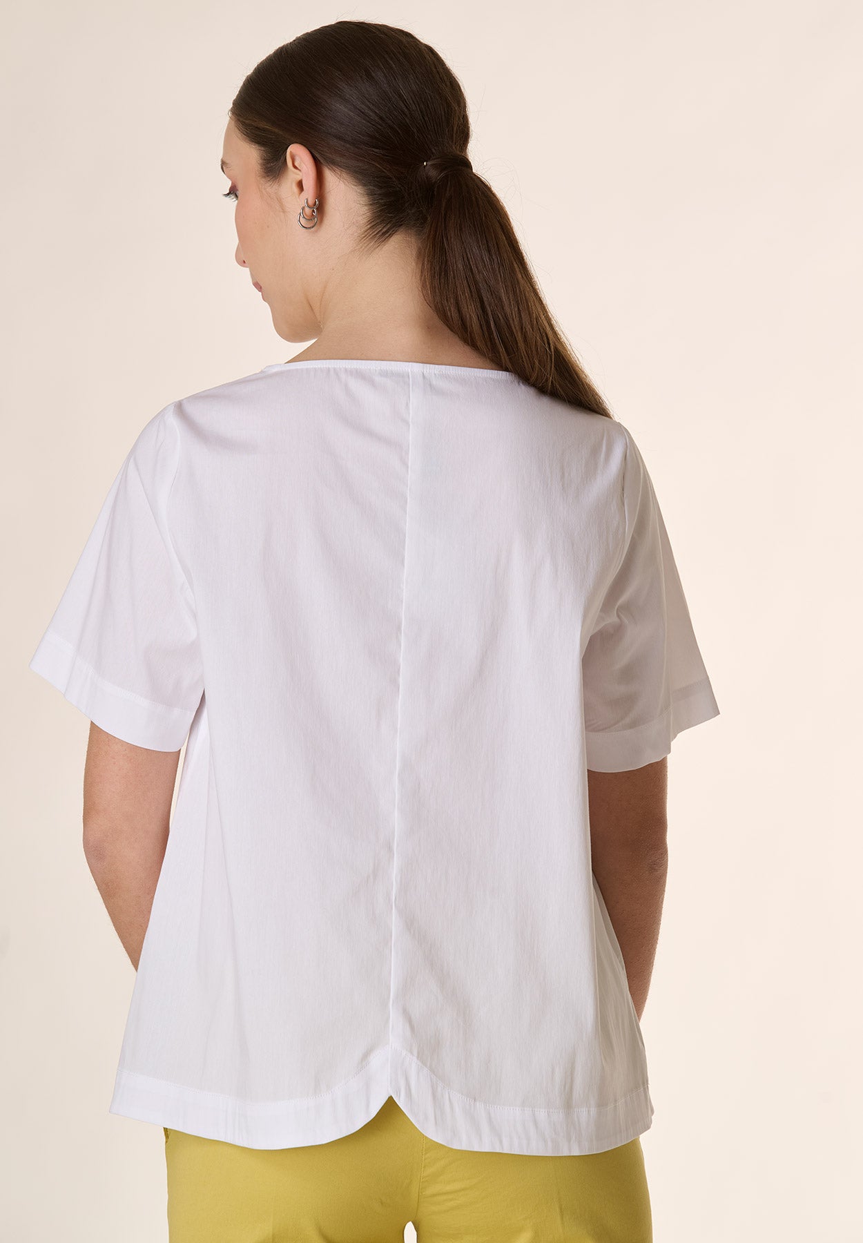 White crew-neck blouse with rounded back
