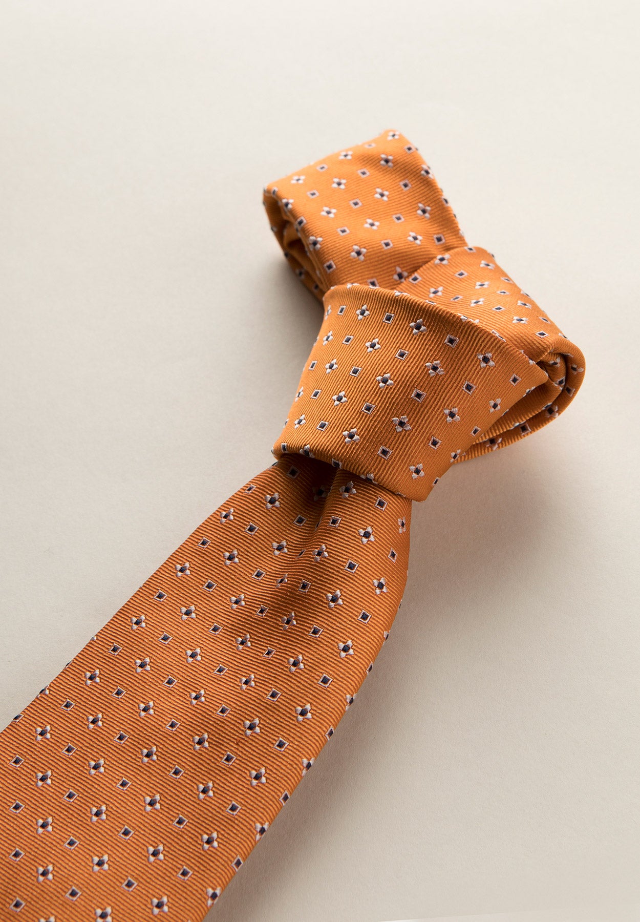 Silk flower patterned orange tie