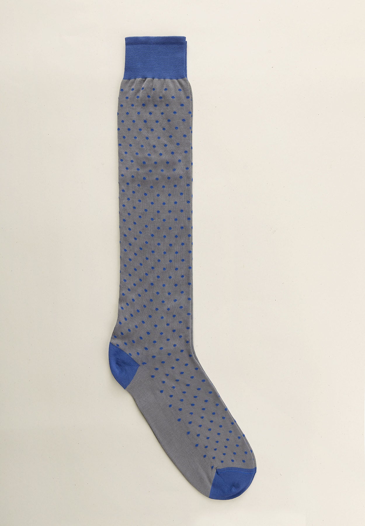 Light grey sock with blue polka dot pattern and Scottish yarn