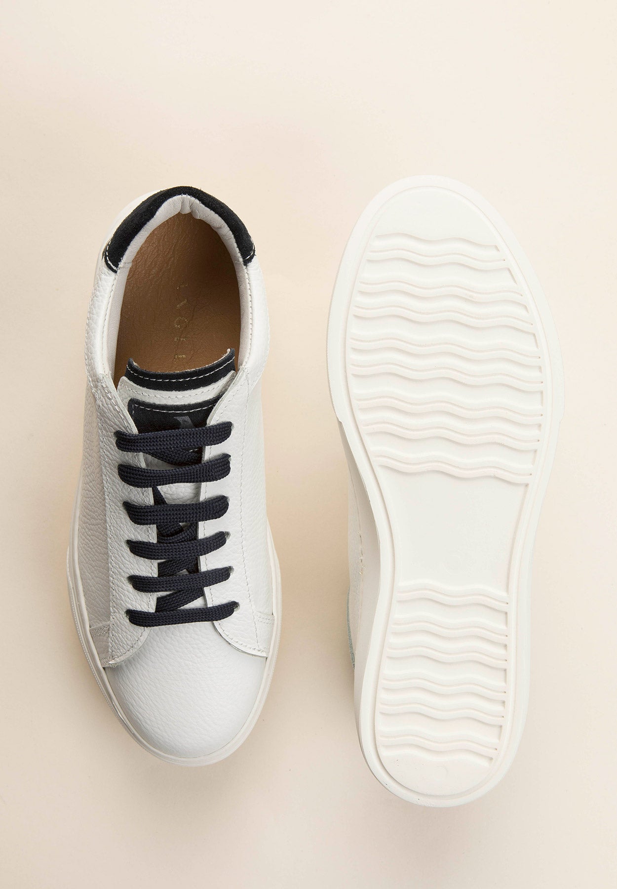White leather sneakers with blue laces