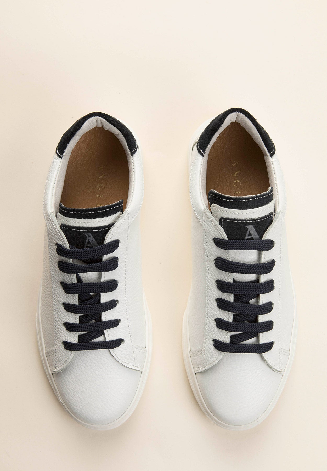 White leather sneakers with blue laces